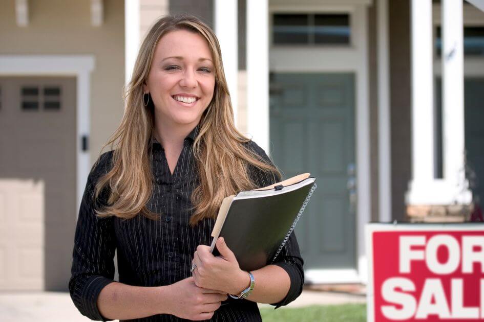 Smiling realtor with clipboard